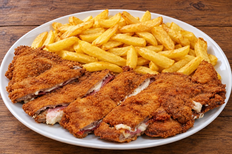 Traditional Asturian cachopo filled with ham and cheese