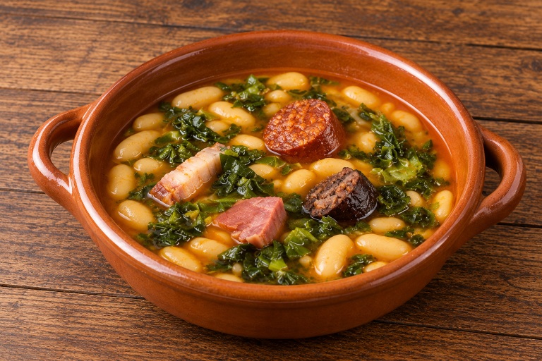 Traditional Asturian pote with white beans, collard greens, potatoes and compango